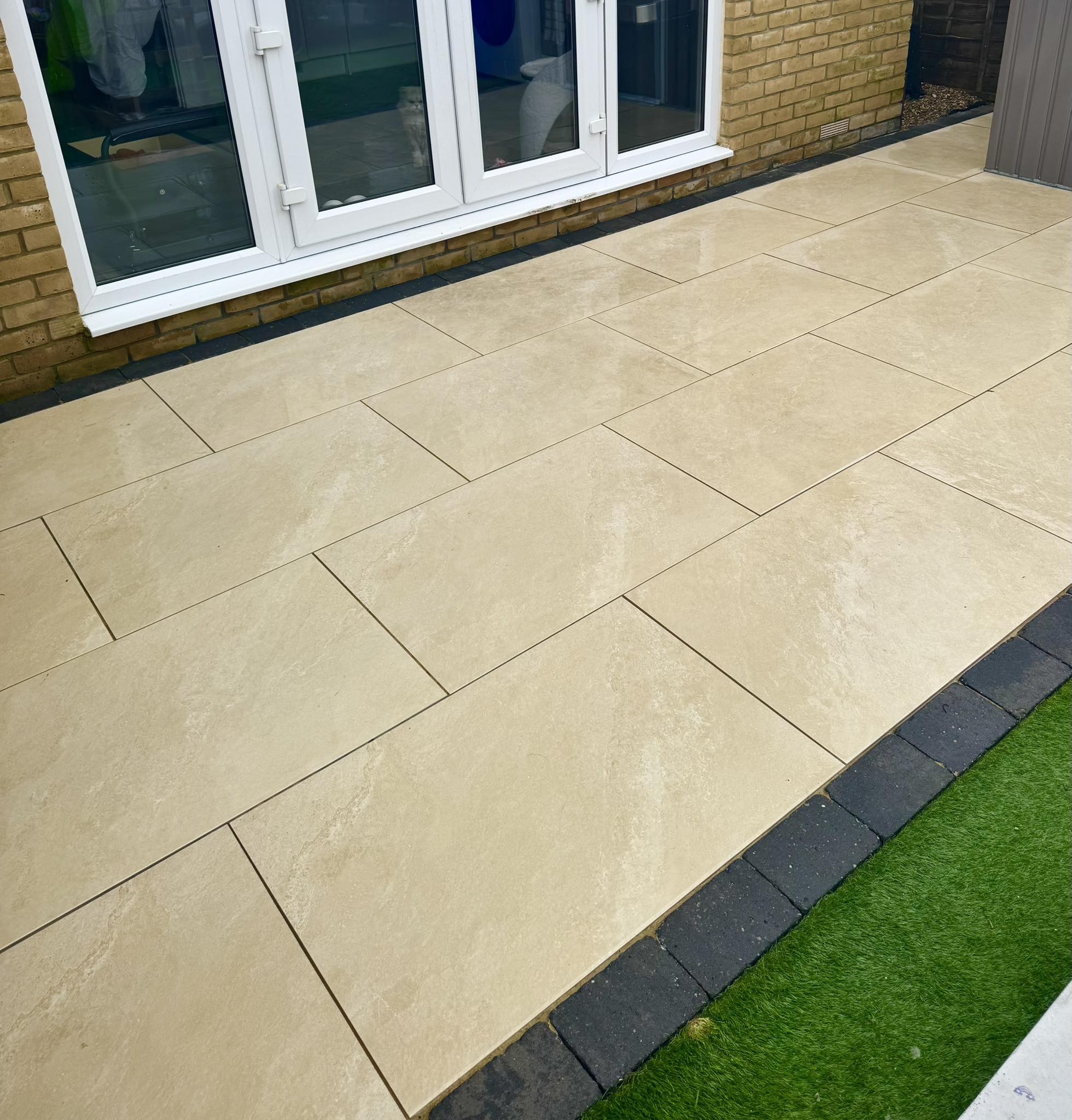 Cleaned slab patio in Berkshire after professional pressure washing, chemical treatment, and sealing by Glanville Exterior Cleaning